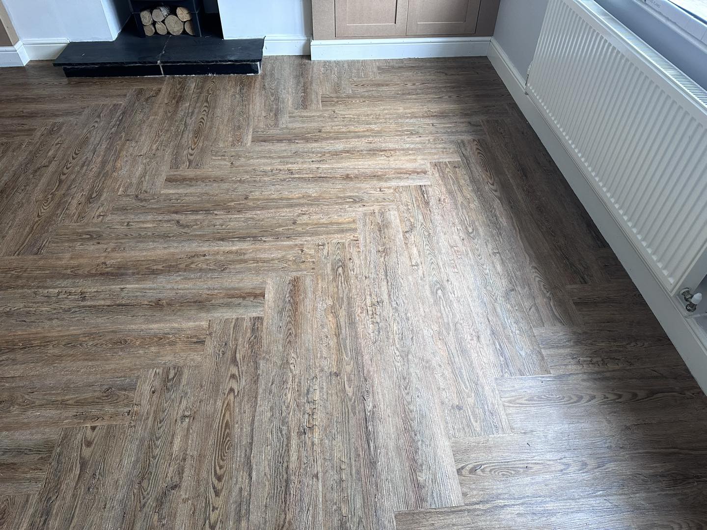 Laminate flooring laid in a herringbone pattern by Lloyd's Carpet & Furnishings